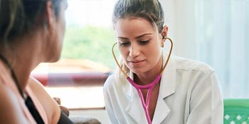 A Physician Assistant student working with a patient