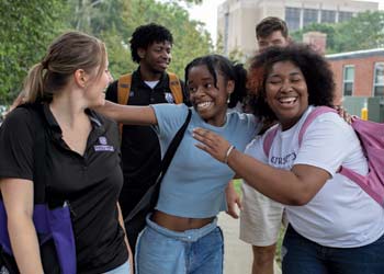 a group of students walking on campus