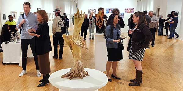 People talking throughout the art gallery