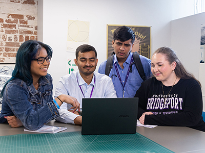 UB students gathered around an admissions officer