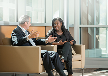 two business students sitting and talking