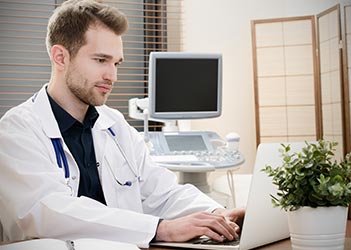 UB chiropractic student on a laptop