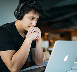 A UB English Language Institute student with headphones