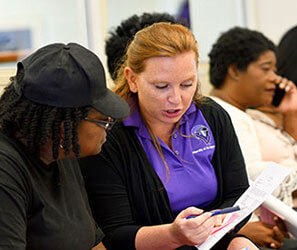 UB Financial Aid staff member working with a student