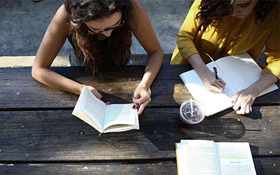 UB students studying at a picnic table
