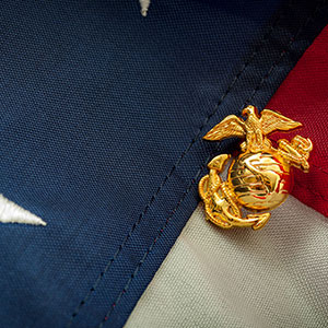 A US Marines pin on an American flag