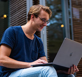 UB online student with a laptop