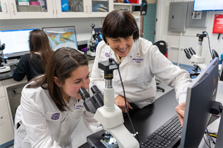 2 female grad students in lab coats