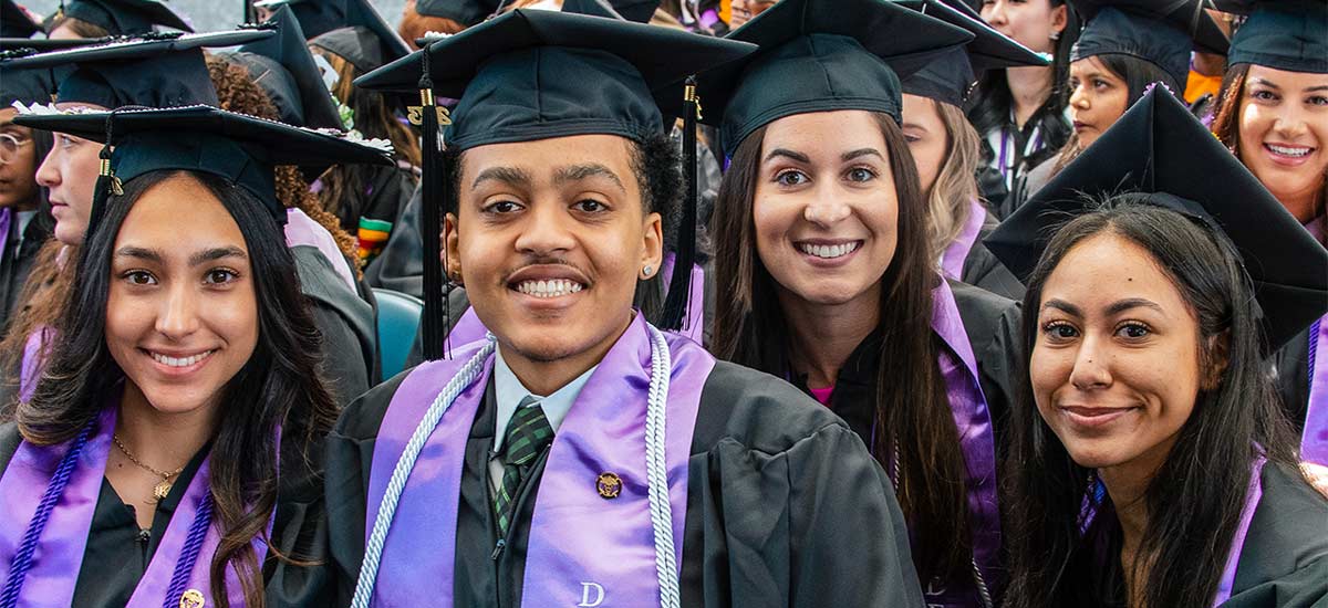 University of Bridgeport graduate in front of the water