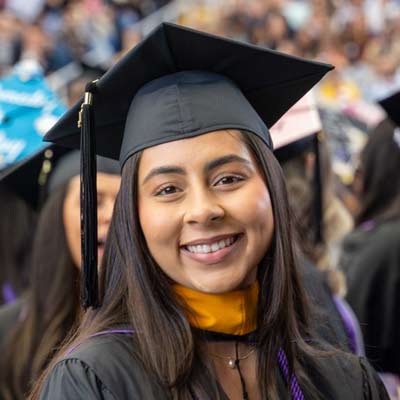 smiling graduate at Commencement