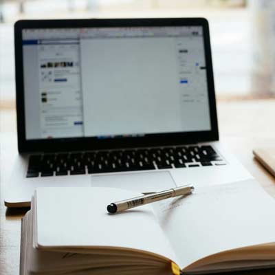 laptop screen and open book