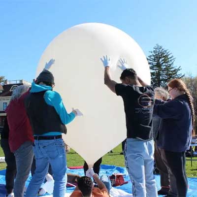 students standing around a stratospheric balloon before launch