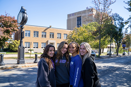 group of 4 smiling students