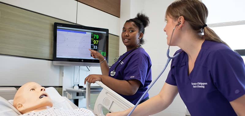 Two nursing students in the Sim Lab