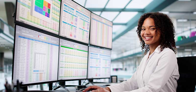 Medical Billing and Coding professional working on 4 monitors