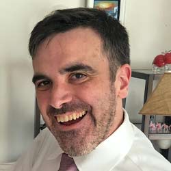 headshot of Andrew
